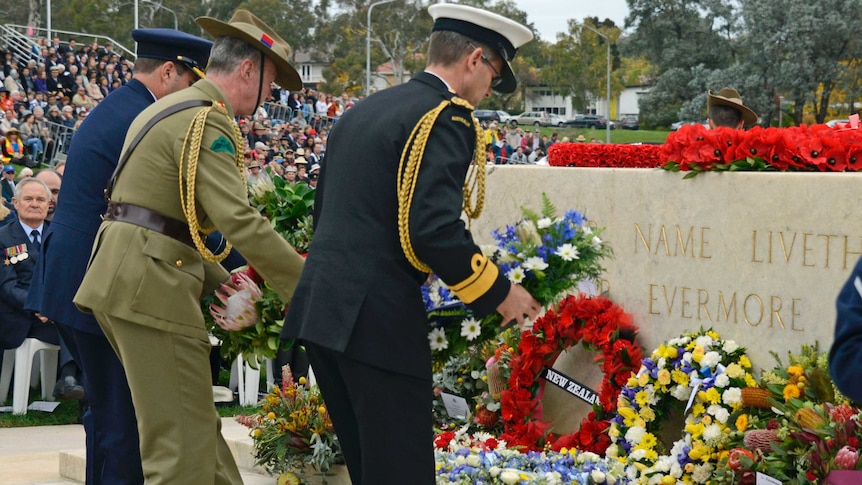 Representatives of the chiefs of Army, Navy and Air Force lay wreaths at the Stone of Remembrance.