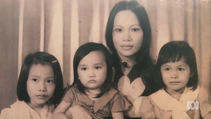 An old portrait photo of Vietnamese mother and her children