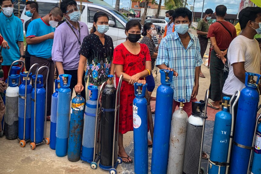 Residents in Yangon queue up to refill their oxygen cylinders at a donation facility amid the coronavirus crisis