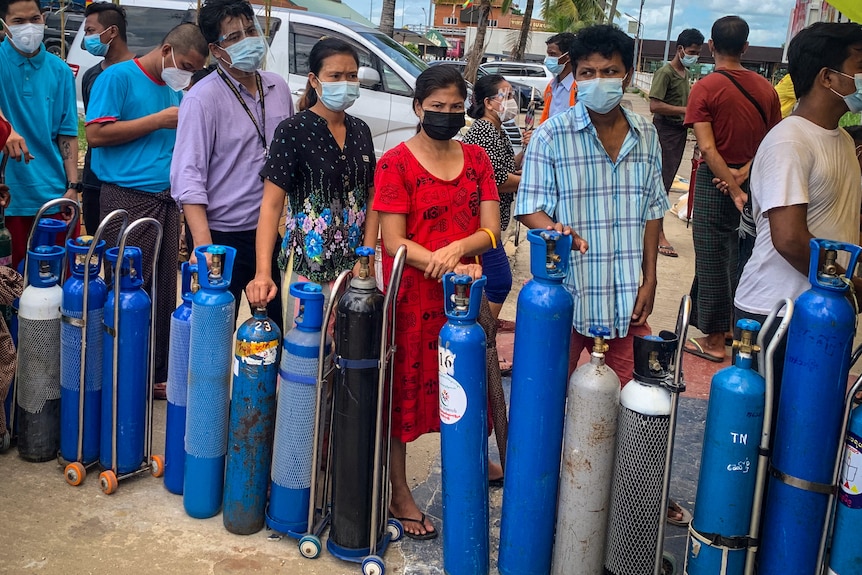 Residents in Yangon queue up to refill their oxygen cylinders at a donation facility amid the coronavirus crisis