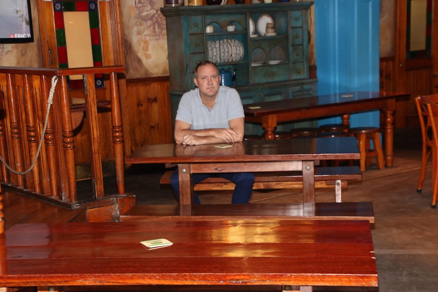 A man sitting in an empty pub in Queensland. 