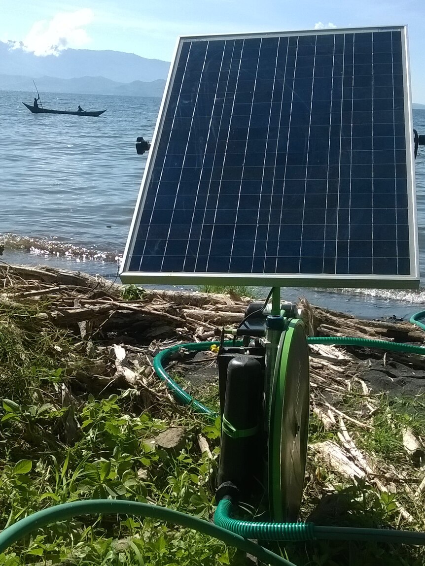 solar panel near a lake, with boat in background