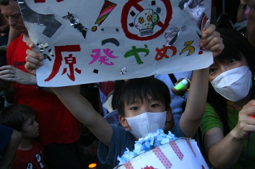 A child takes part in the demonstration in Tokyo on July 29.