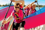 Women paddling on a dragon boat for a story about the sport's health benefits, common injuries and how to get started.