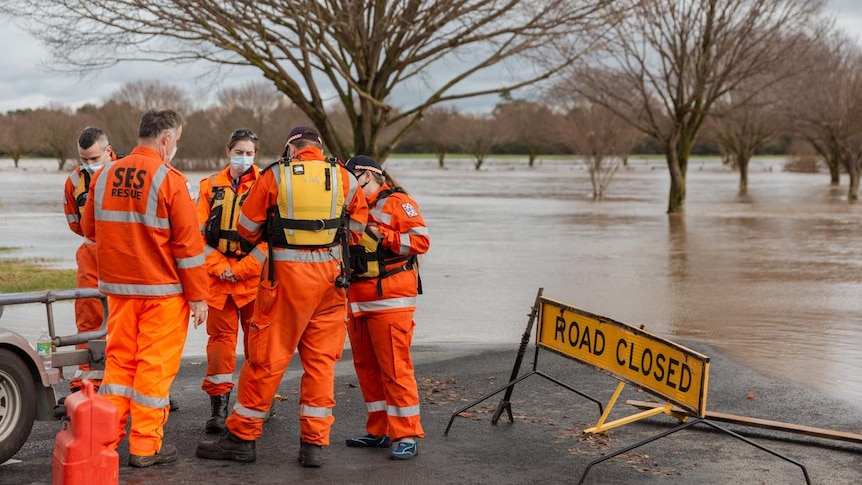 SES volunteers gather at flooded road