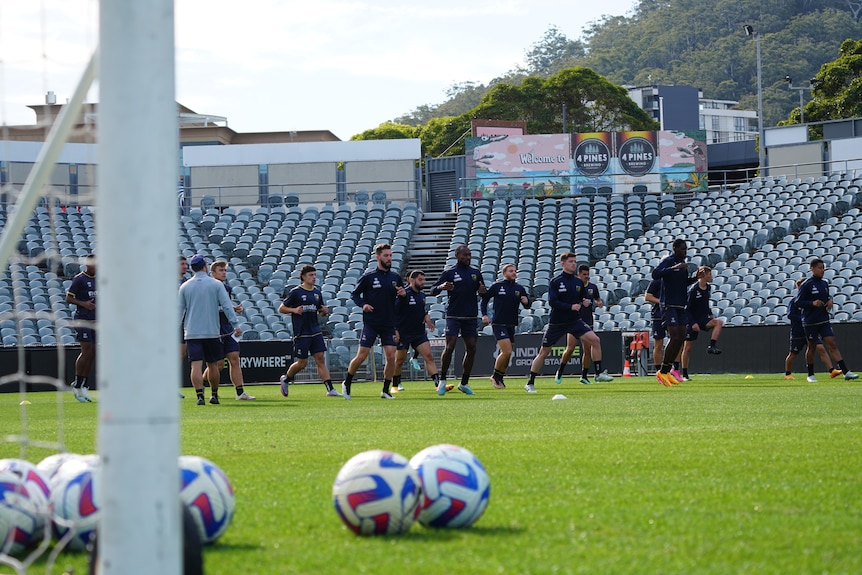 Central Coast mariners players training at a stadium