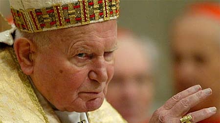 Pope John Paul II waves as he arrives at the altar in St Peter&#39;s Basilica in the Vatican City.