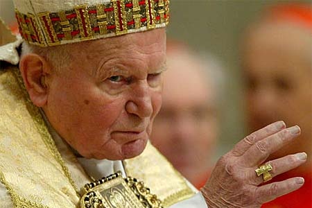 Pope John Paul II waves as he arrives at the altar in St Peter&#39;s Basilica in the Vatican City.