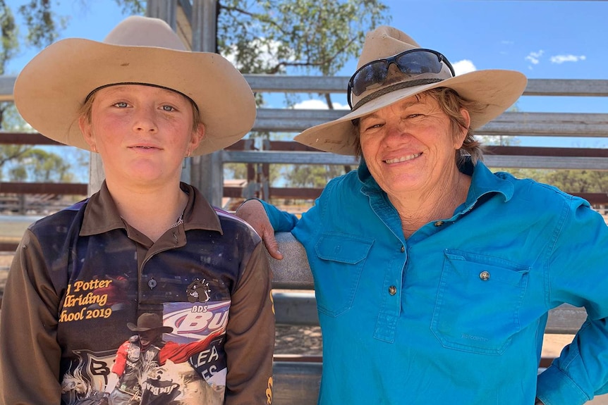 Riley O'Dell (12) and her mum Jacky O'Dell stand in front of a cattle gate.