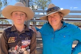 Riley O'Dell (12) and her mum Jacky O'Dell stand in front of a cattle gate.