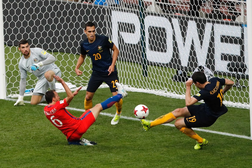 Socceroos' Ryan McGowan clears the ball off the line against Chile