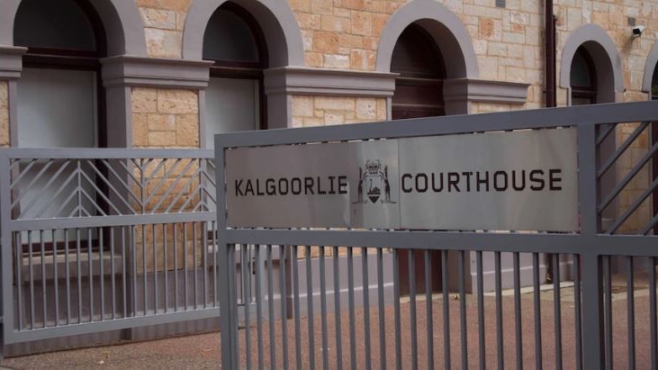 A silver gate with the word Kalgoorlie Courthouse printed on it.