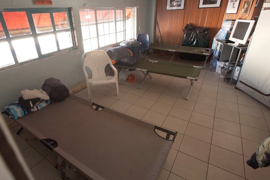 Stretcher beds, a tv and fridge inside The Bunker