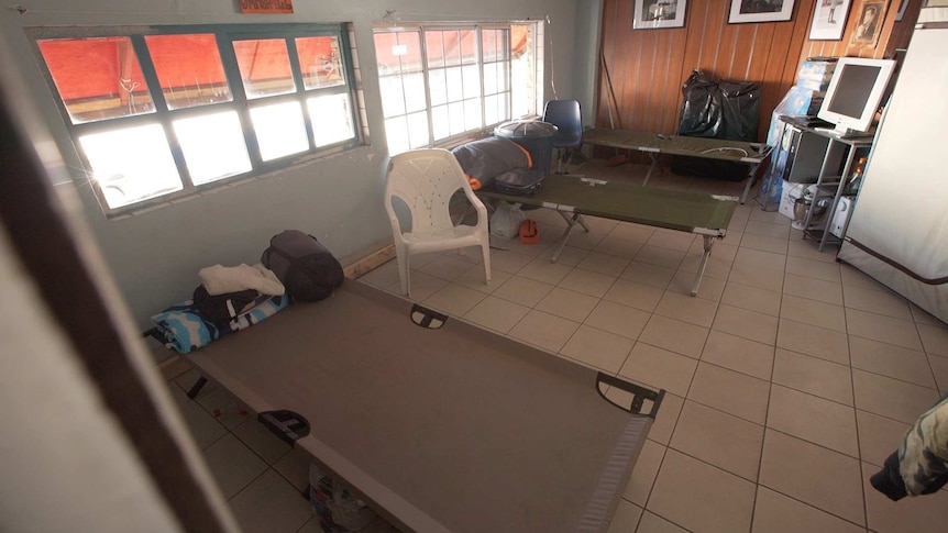 Stretcher beds, a tv and fridge inside The Bunker