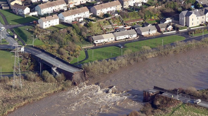 A collapsed bridge is seen following flooding in Cumbria, in northern England,November 20, 2009.