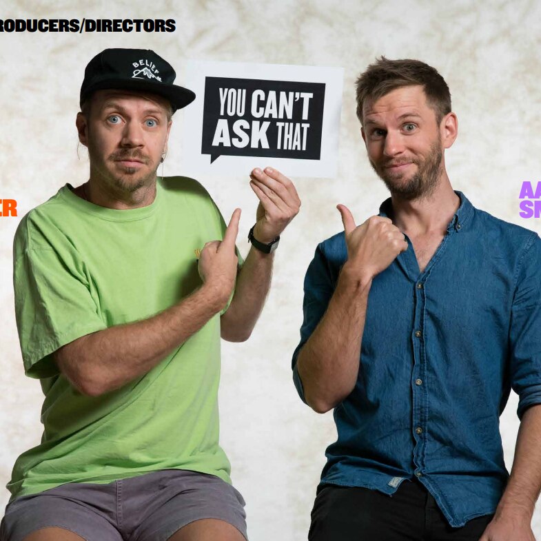 You Can't Ask That producers/directors Kirk Docker and Aaron Smith hold and point to the show's logo on set.