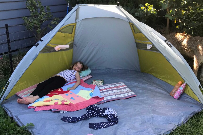 Alex Hughes' daughter in a backyard tent