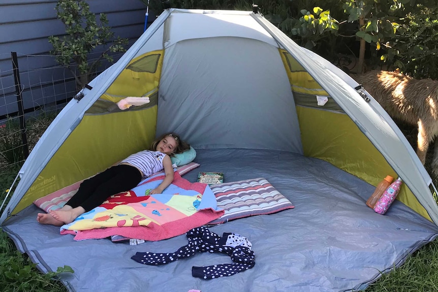 Alex Hughes' daughter in a backyard tent