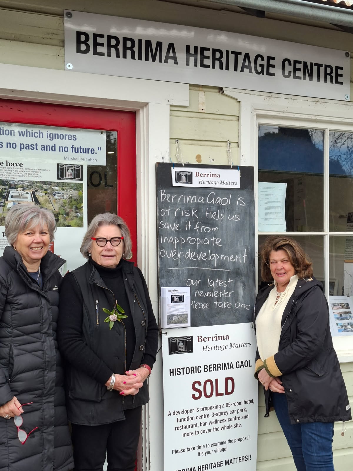 Three woman standing in front of chalk board