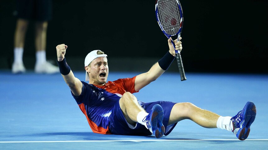 Winning feeling ... Lleyton Hewitt drops to the ground in celebration after beating James Duckworth in straight sets