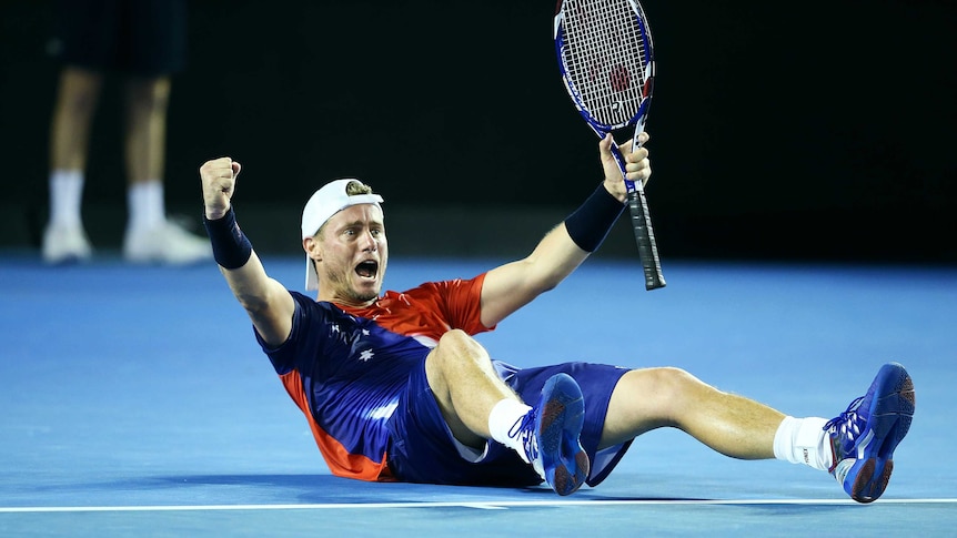 Winning feeling ... Lleyton Hewitt drops to the ground in celebration after beating James Duckworth in straight sets