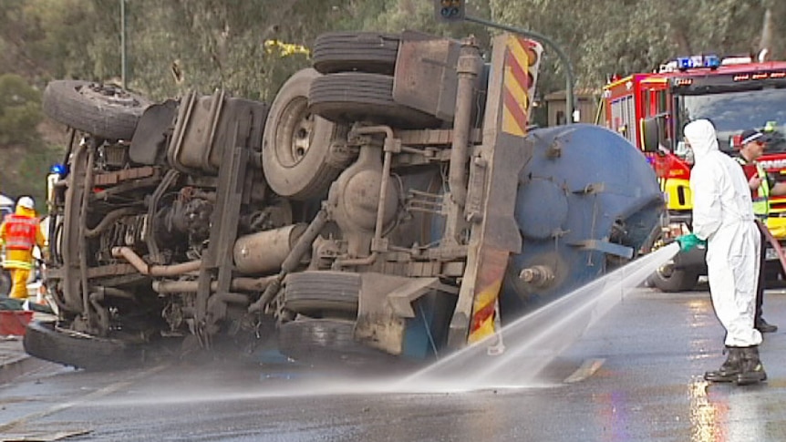 Emergency services clean up truck crash