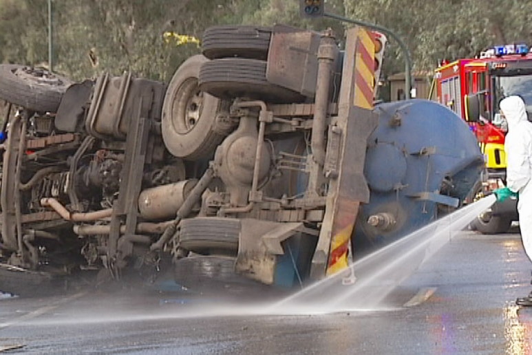 Emergency services clean up truck crash