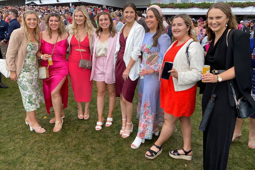 A group of women lined up at the Melbourne Cup.