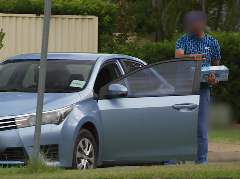 A man emerges from an Uber car with a canister of nitrous oxide.