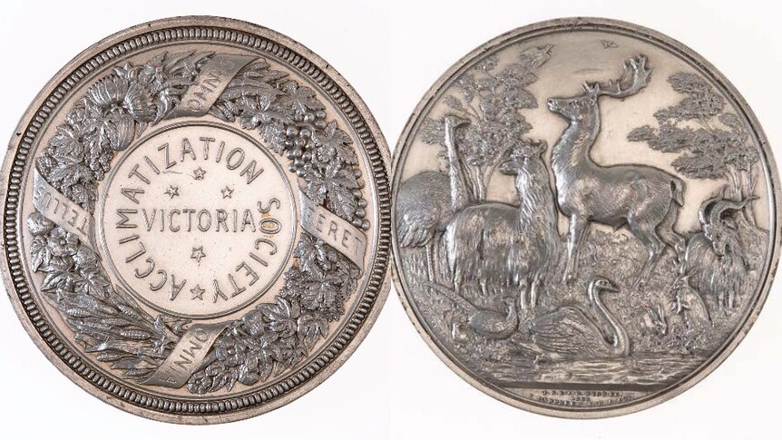 The two sides of a silver medal.  On the left the words Acclimatisation Society of Victoria. On the right animals in the bush
