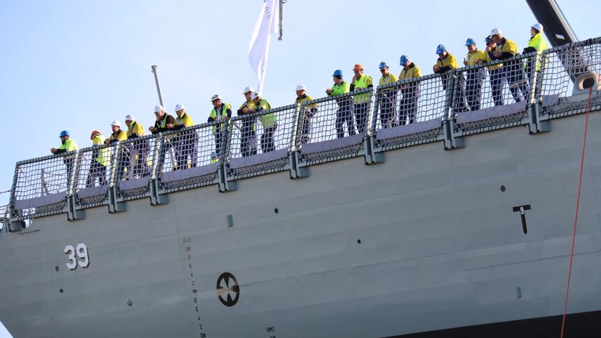 Workers on board HMAS Hobart at launch