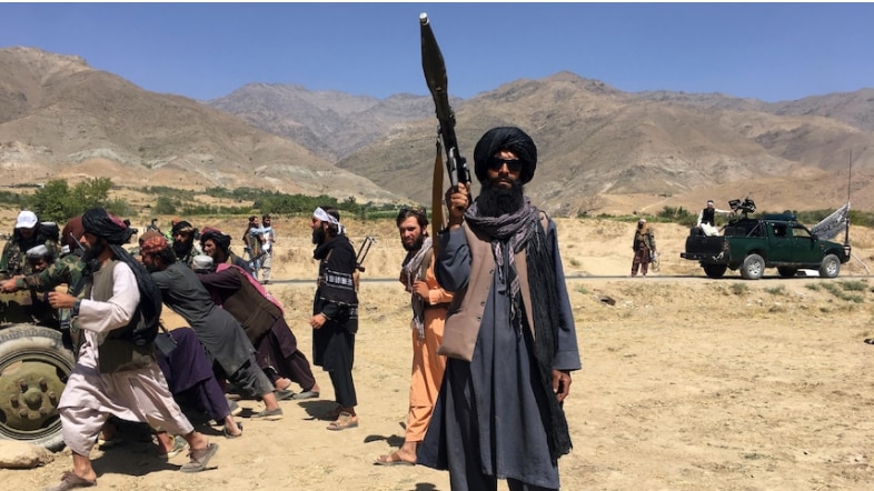 A Taliban soldier holds a gun.