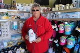 Shirley Lincoln holding a toy penguin.