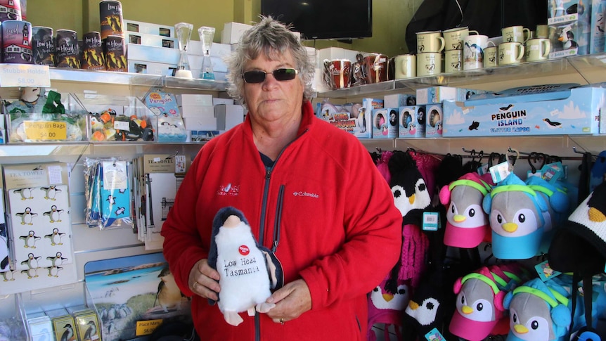 Shirley Lincoln holding a toy penguin.