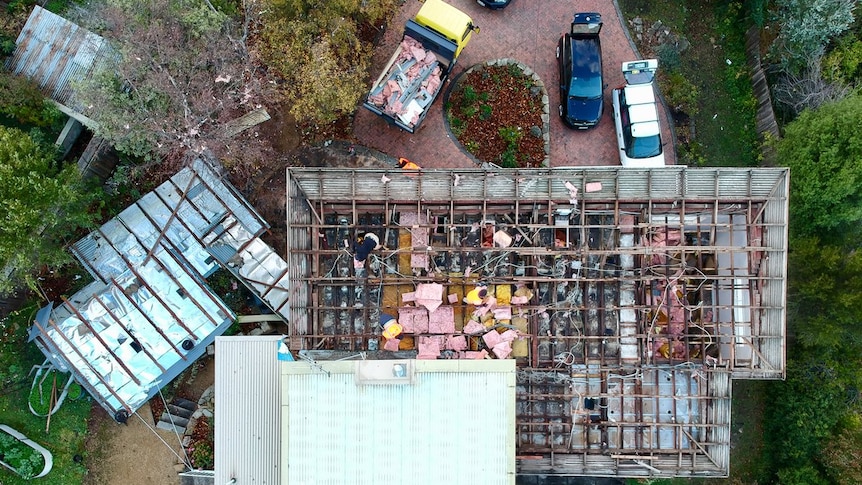 An aerial shot of a house which had its roof removed