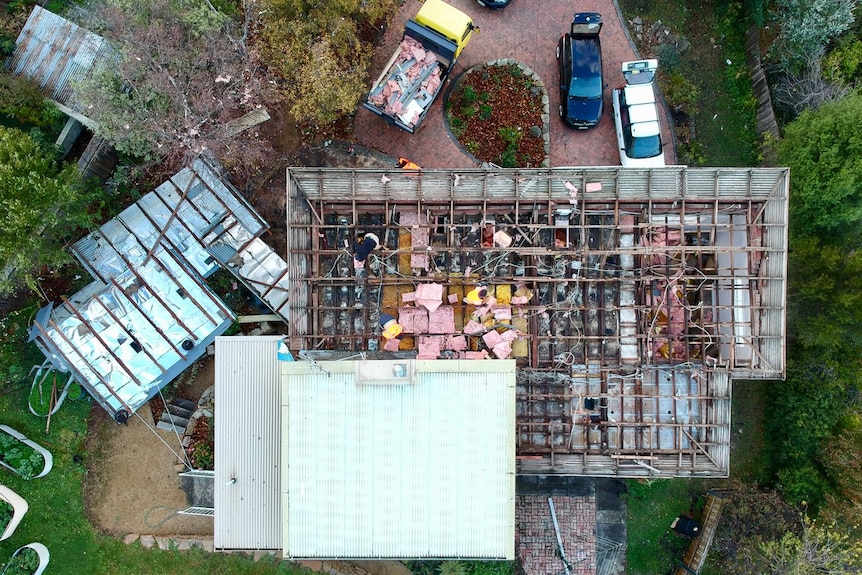 An aerial shot of a house which had its roof removed