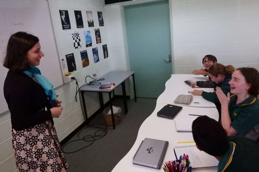 Steph Bowe talking to students in a classroom, pictured in obituary for Steph Bowe