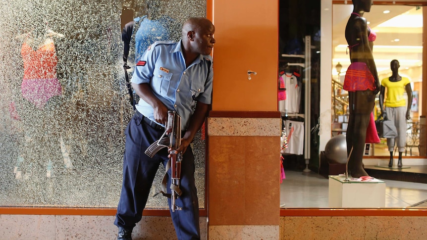 A police officer secures an area of the mall.