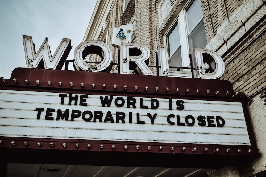 A sign says "The world is temporarily closed"