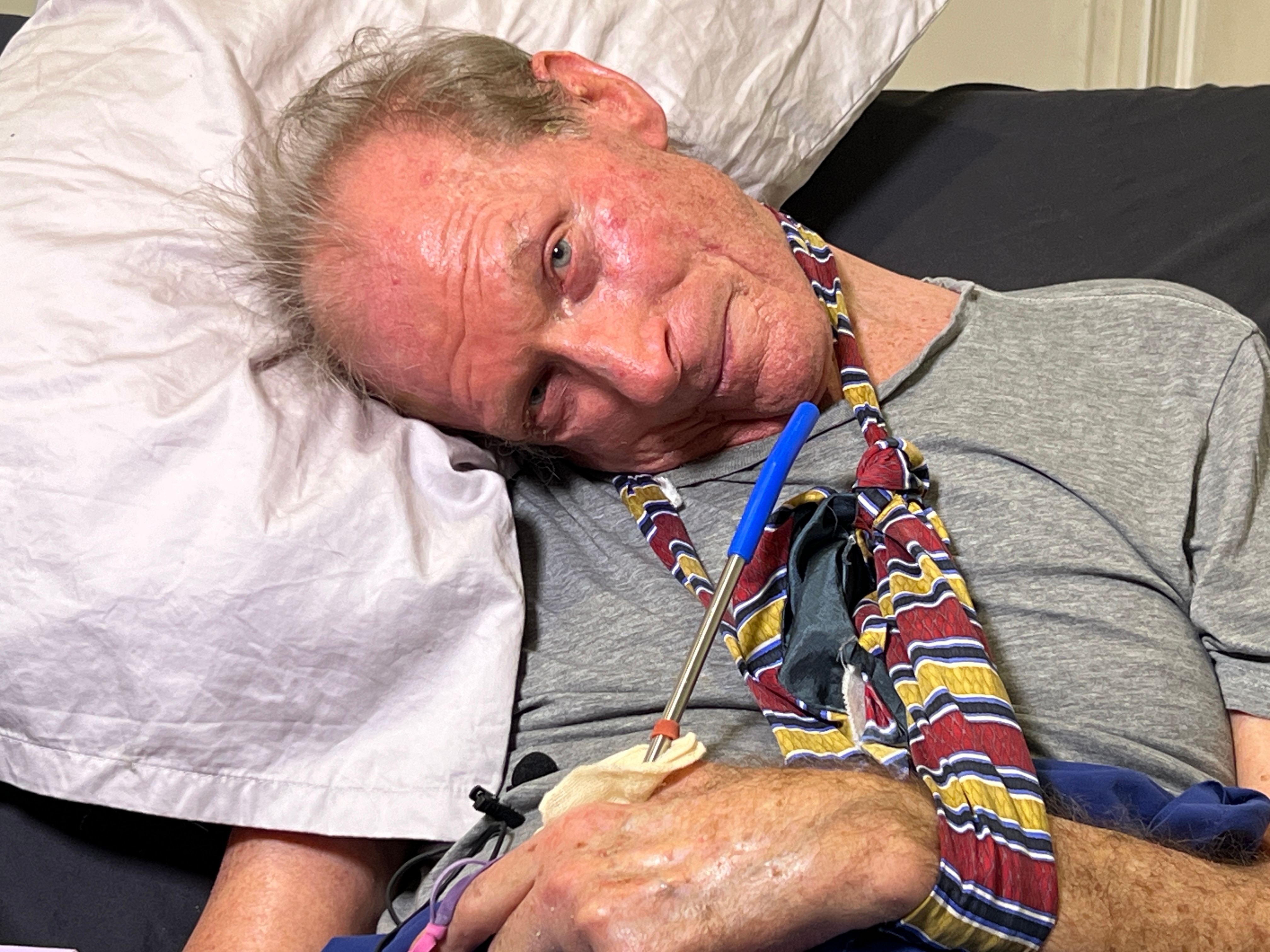 a man with his head resting on a pillow at a sharp angle.