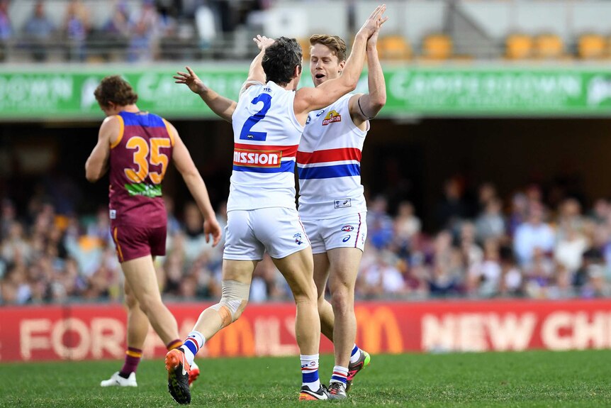 Robert Murphy of Western Bulldogs (front L) celebrates a goal against Brisbane on August 5, 2017.
