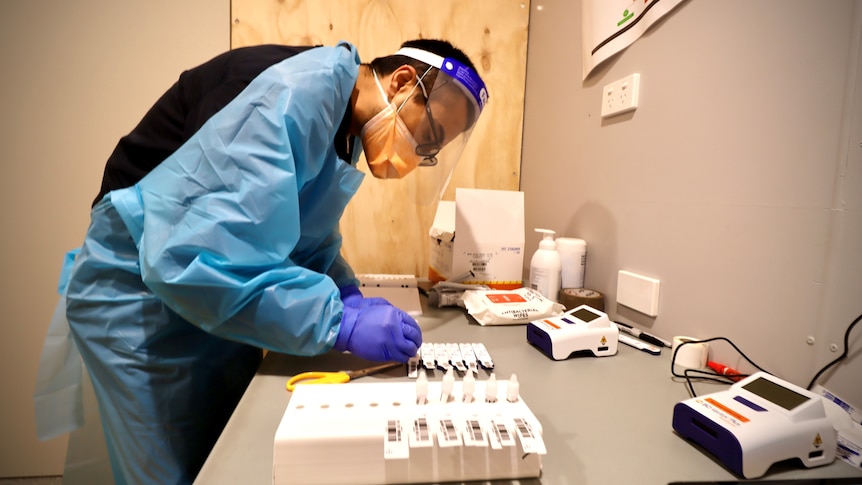 a sign saying rapid antigen testing at a building site