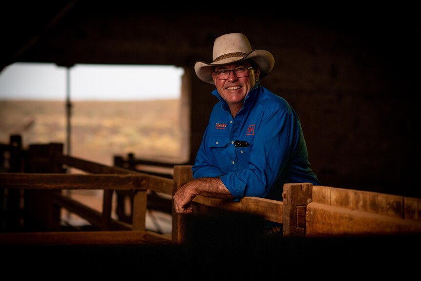 South Australian cattle farmer Ross Fargher leans against railings.