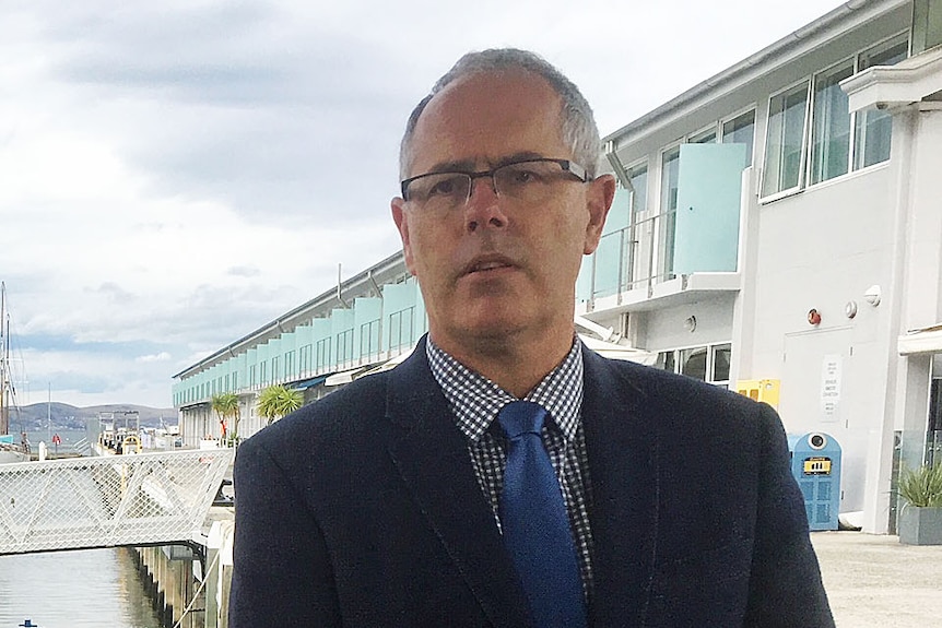 Wes Ford,  Director Tasmanian Environment Protection Authority, stands on a dock in Hobart.