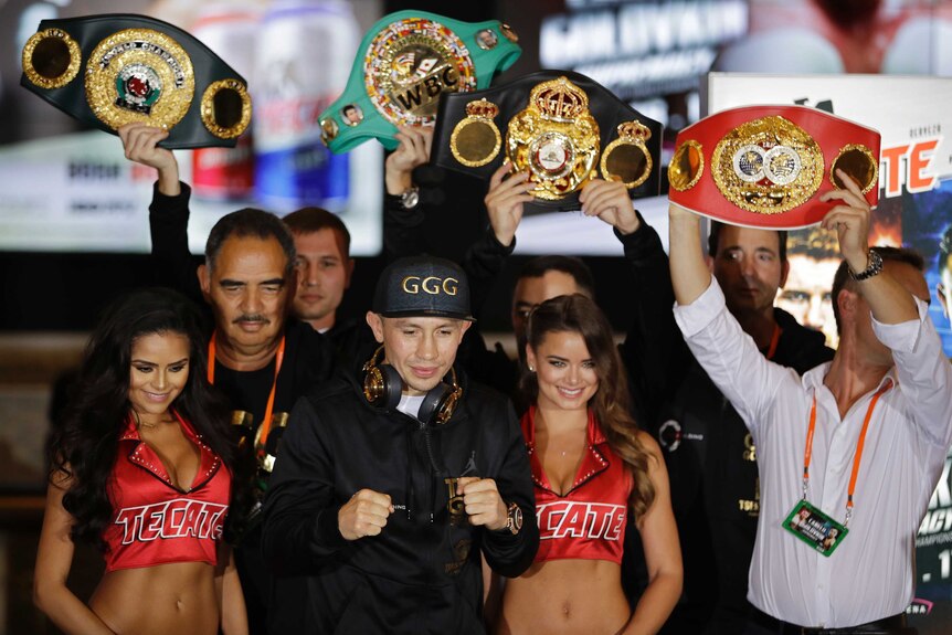 Gennady Golovkin poses with his title belts