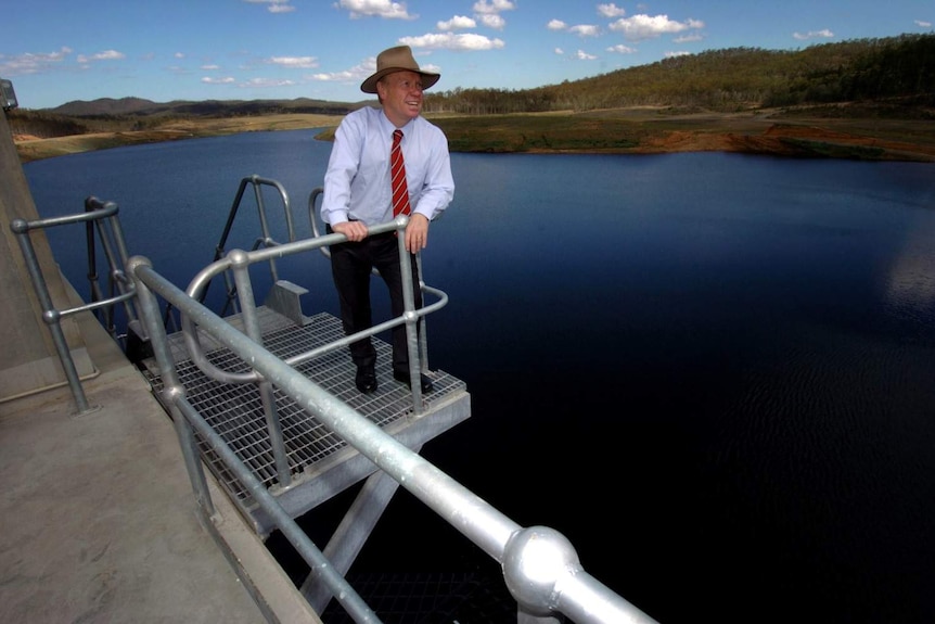 Then Queensland premier Peter Beattie leans over a railing at Paradise Dam.