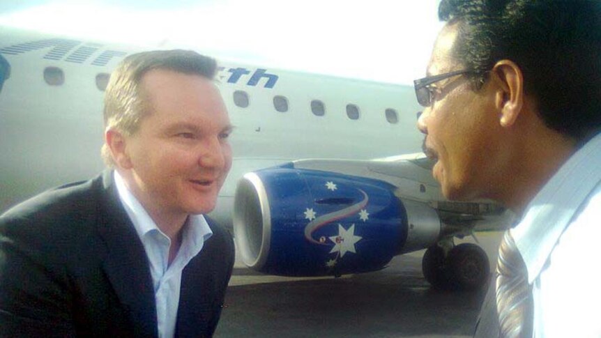 Immigration Minister Chris Bowen is greeted upon his arrival in Dili.