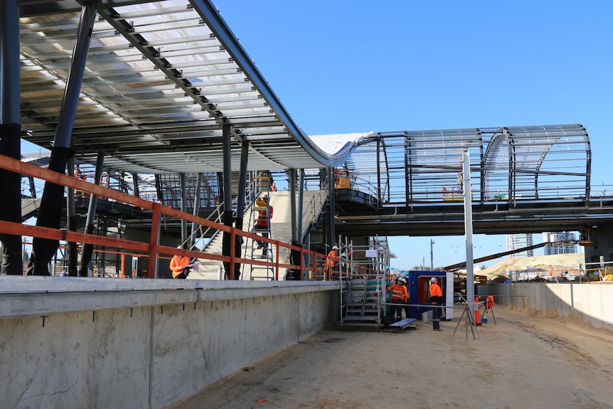 A train station concourse and overpass under construction.
