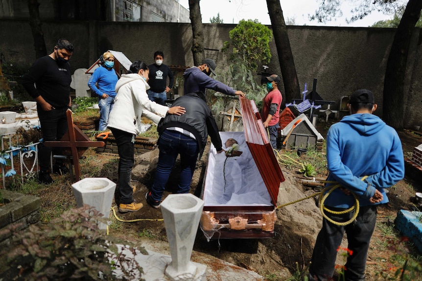 Relatives bury a man in a Mexican cemetery.