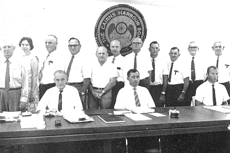 A black and white photograph showing the members of the Cairns Harbour Board standing underneath the now missing plaque.